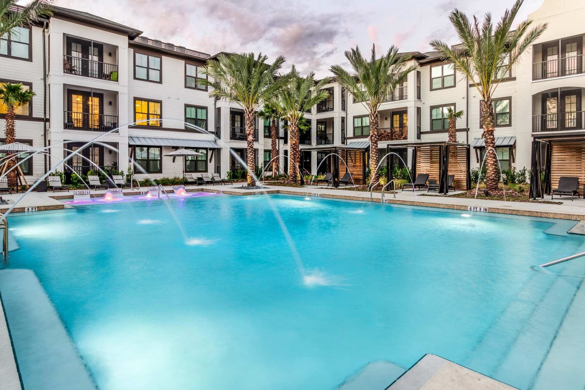 Outdoor swimming pool with apartment buildings at Brisa at St. Augustine in St. Augustine, Florida