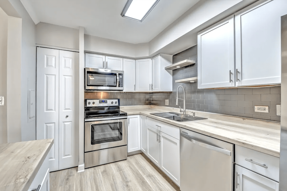 Apartment kitchen with wooden cabinetries at Terraces of Elk Grove in Elk Grove Village, Illinois