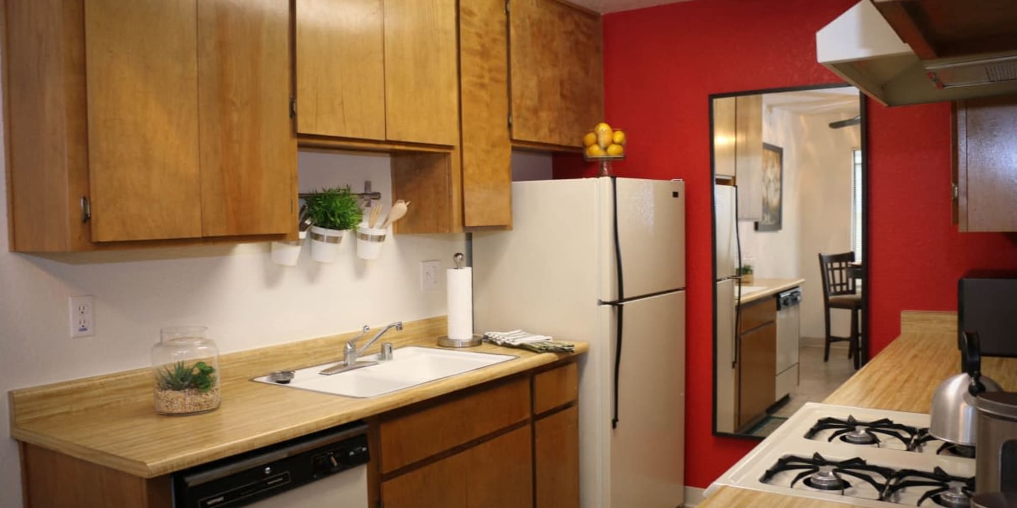 Kitchen with wooden cabinets at Oak Park in Turlock, California