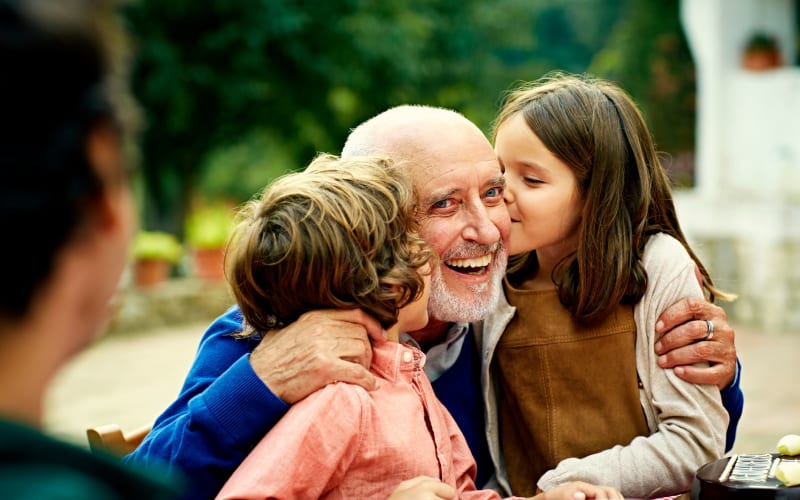 Resident enjoying time with their grandkids at Grand Villa of St. Petersburg in St. Petersburg, Florida