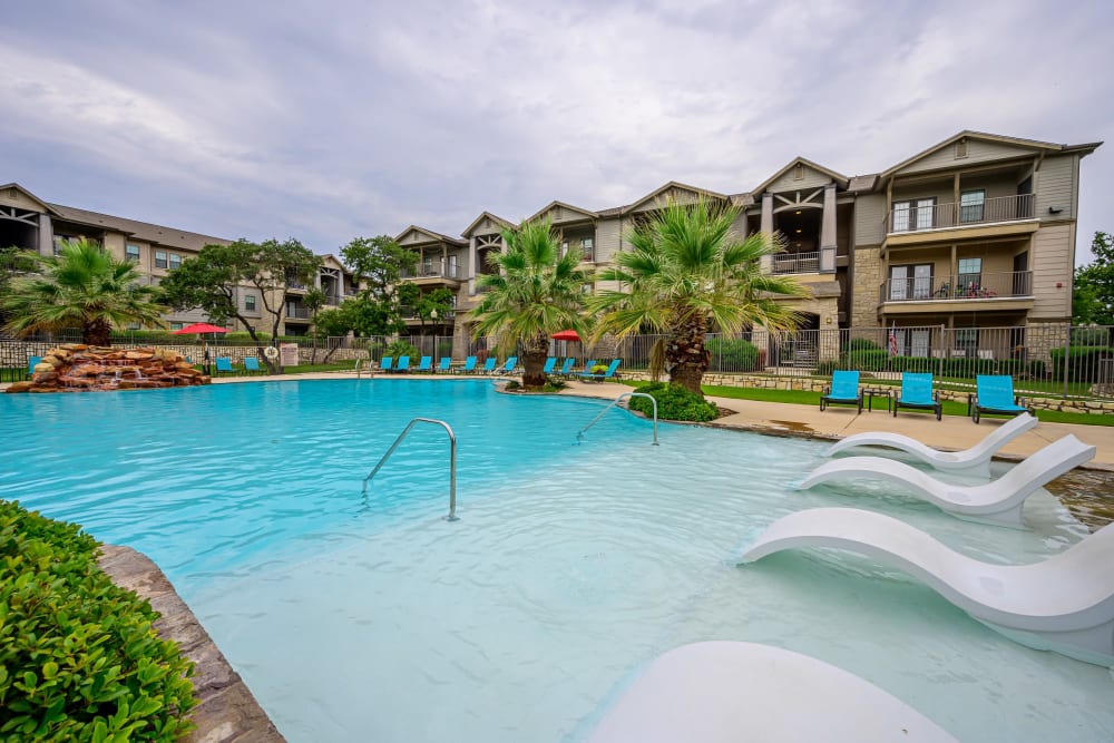 Resort style pool with lounge chairs at Verandas at Shavano in San Antonio, Texas