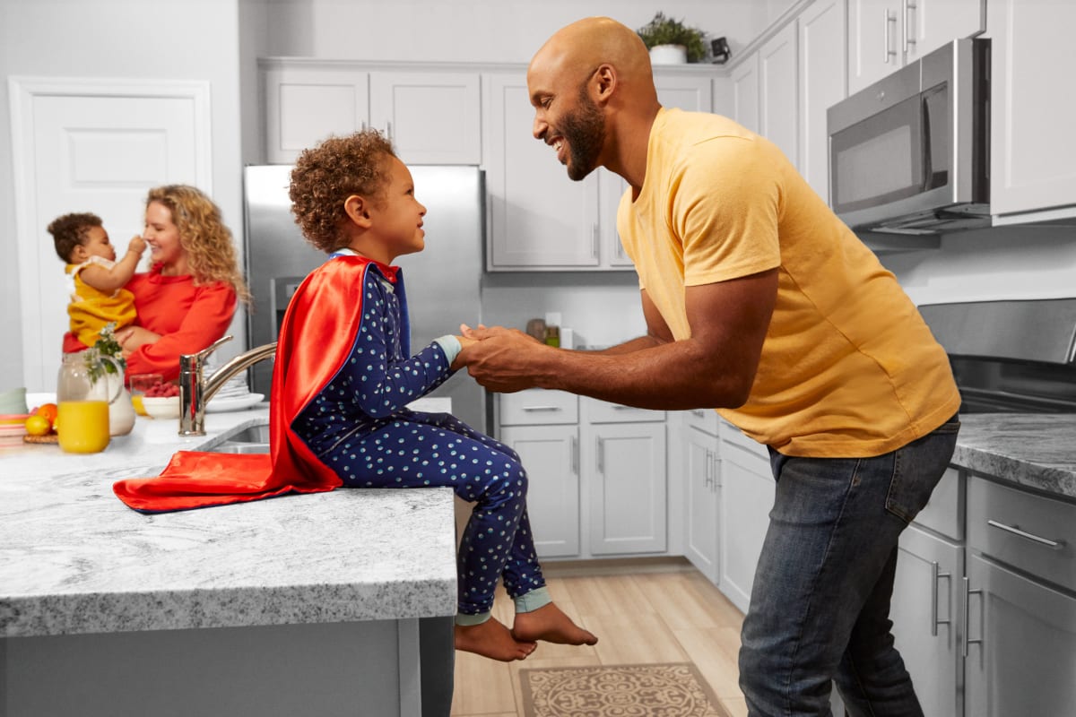 A family gathered in their kitchen at BB Living at Civic Square in Goodyear, Arizona