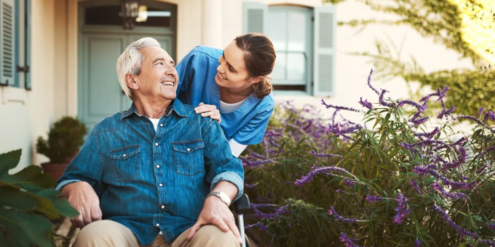 A staff member helping a resident in a wheelchair at Careage Home Health in Dupont, Washington.