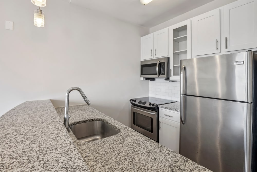 Stainless-steel appliances and granite countertops in kitchen at Terraces at Manchester in Richmond, Virginia