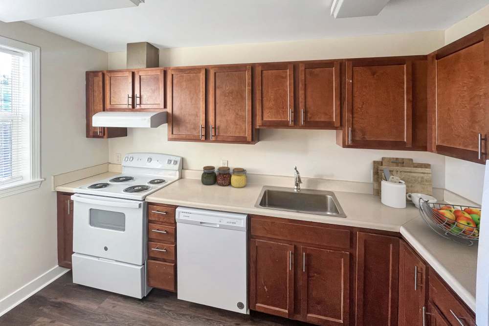 Comvenient kitchen with wooden cabinets at Stony Brook Village in Westford, Massachusetts
