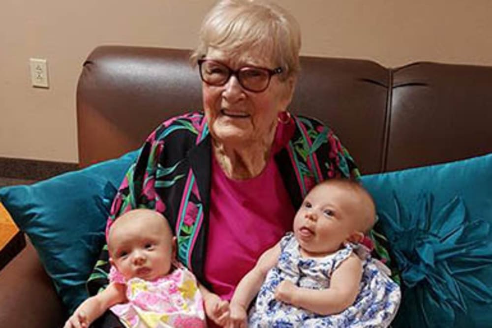 A resident embracing her grandchildren at Peachtree Village Retirement Community in Roswell, New Mexico. 