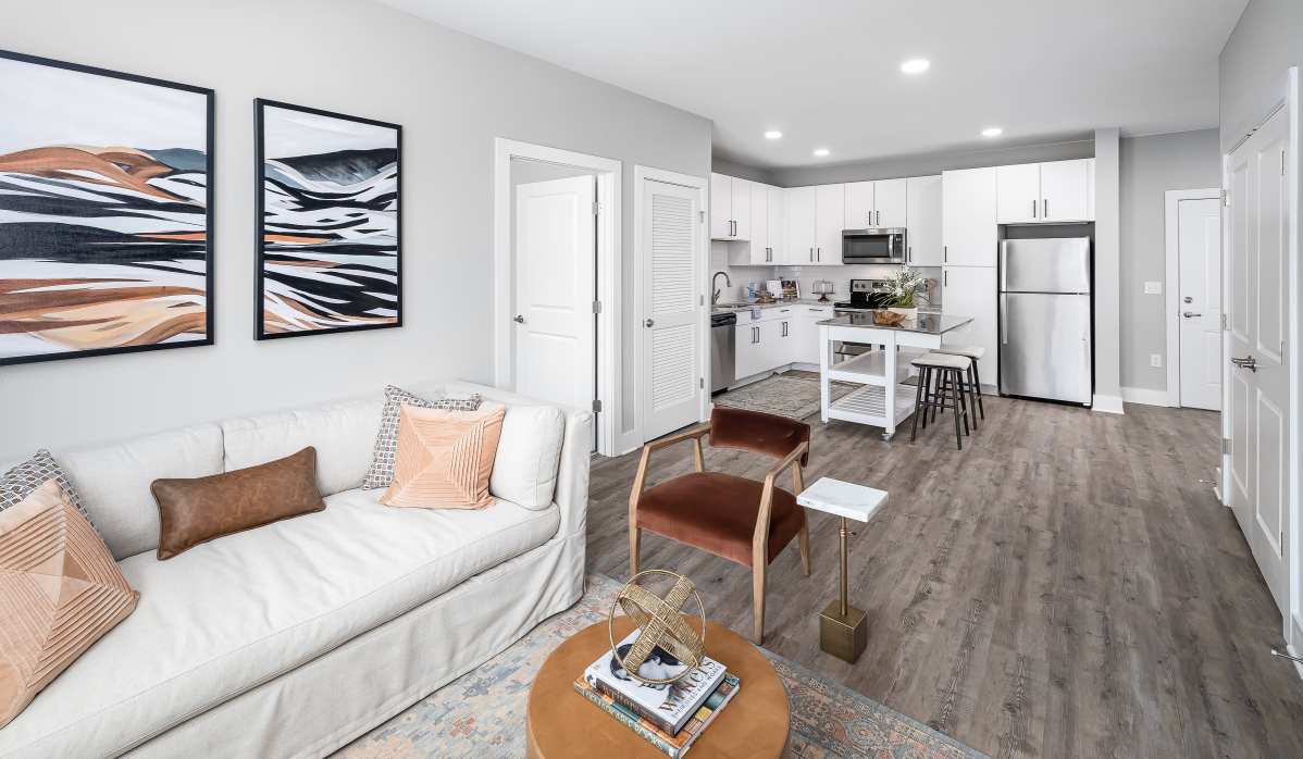 Living room with wall decor and comfortable sofa at The Kingson in Fredericksburg, Virginia