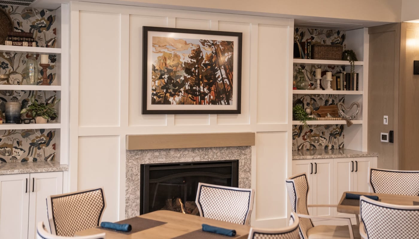 Fireplace with framed art above the mantle at The Pillars of Lakeville in Lakeville, Minnesota