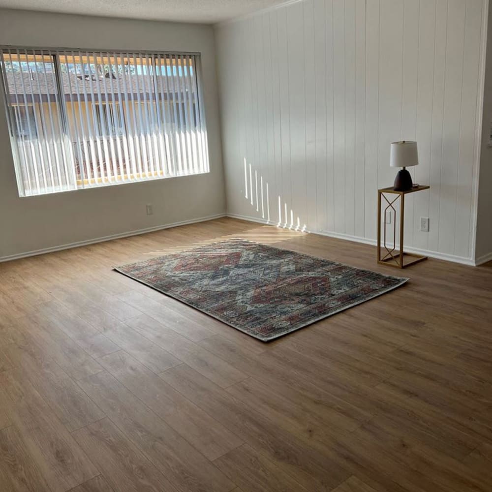 Wood-style flooring with a rug at Park Place in Manteca, California