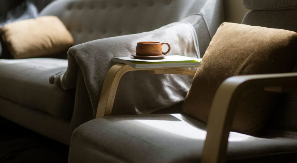 Living space with wall-to-wall carpeting and leather seating at Glendora Gardens in Glendora, California