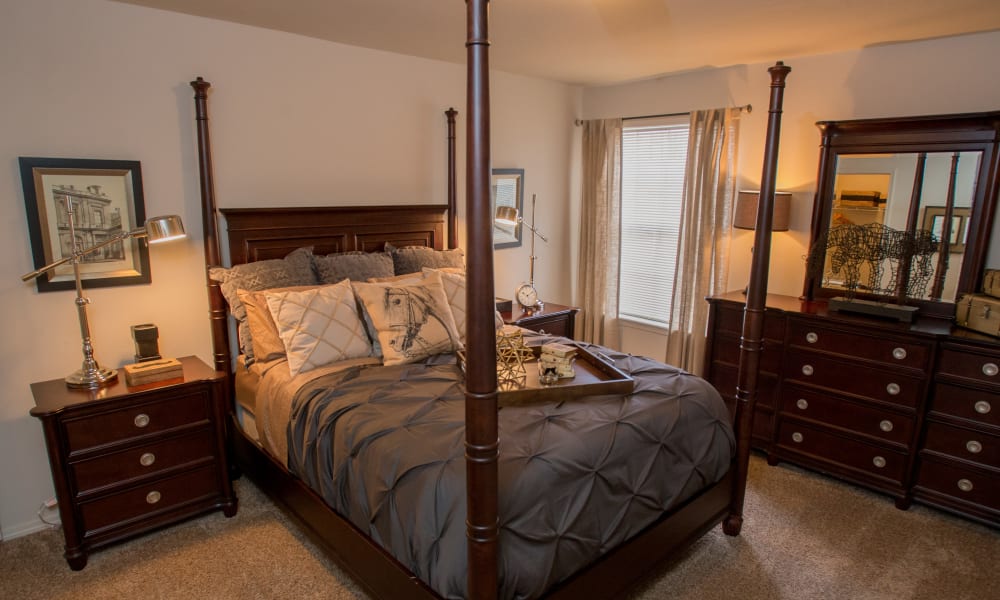 Cozy master bedroom with ceiling fan at Villas of Waterford Apartments in Wichita, Kansas