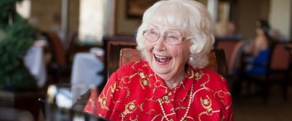 Woman sitting at a counter smiling and laughing near The Compass at Springdale Park in Richmond, Virginia