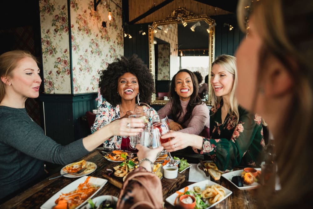 Friends out eating at a restaurant near Legacy at Meridian in Durham, North Carolina