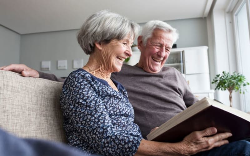 Residents looking through a photo albulm at Grand Villa of DeLand in DeLand, Florida
