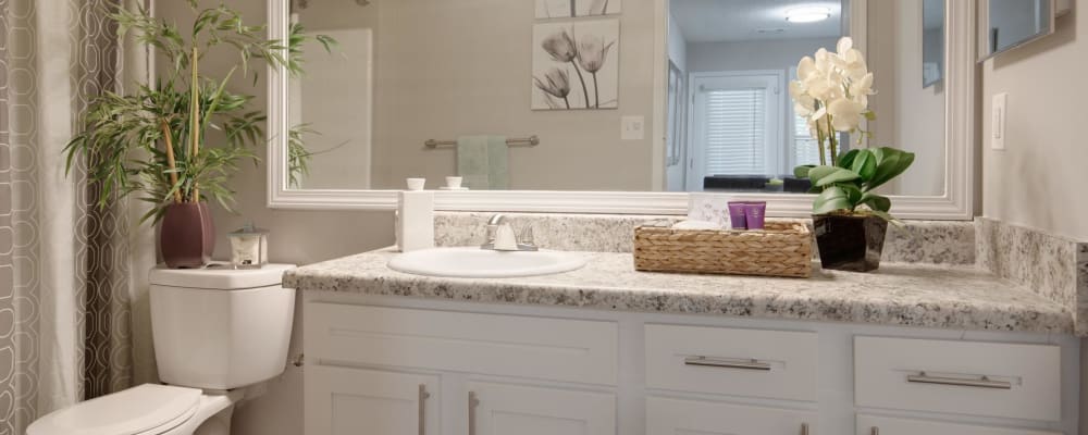 White cabinets with silver handles in an apartment bathroom at Renaissance at Galleria in Hoover, Alabama 