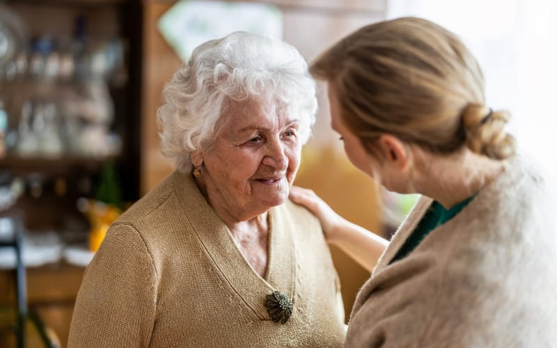 Staff member taking care of resident at Grand Villa of Boynton Beach in Boynton Beach, Florida