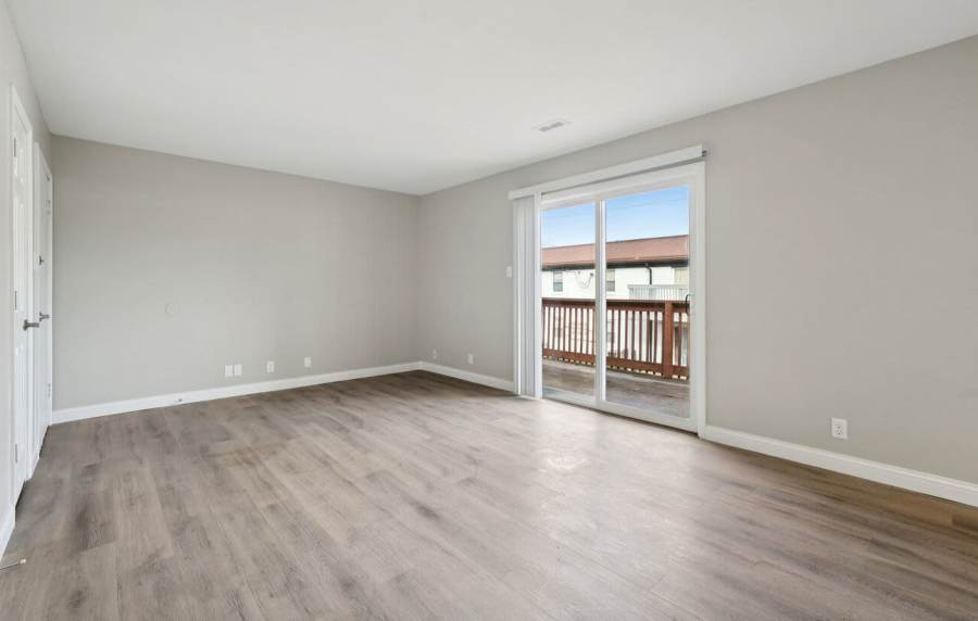 Unfurnished living with access to patio at Charleston Square Apartments in Columbus, Indiana