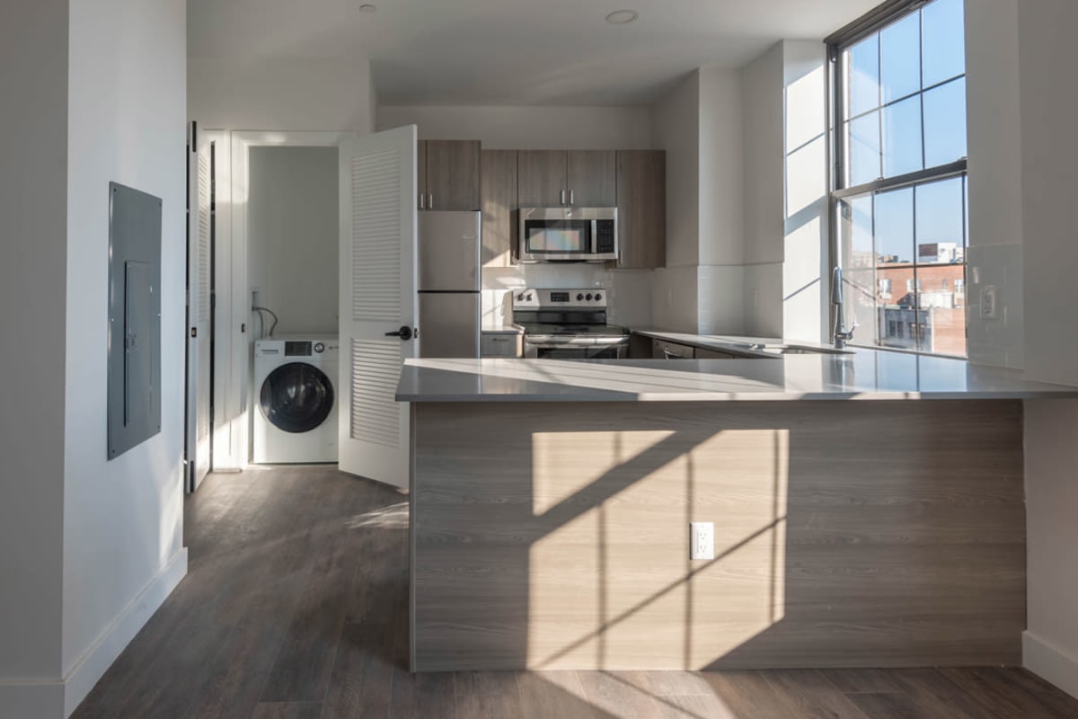 Apartment kitchen with wood-style flooring at The One Atlantic in Stamford, Connecticut