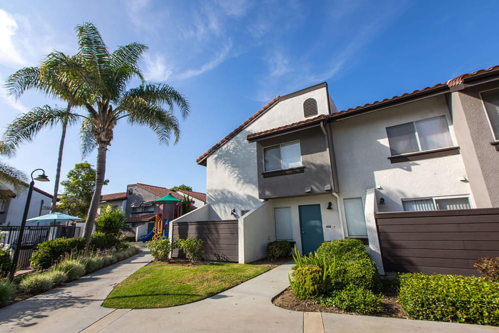 Townhomes surrounded by palm trees at Portofino Townhomes in Wilmington, California