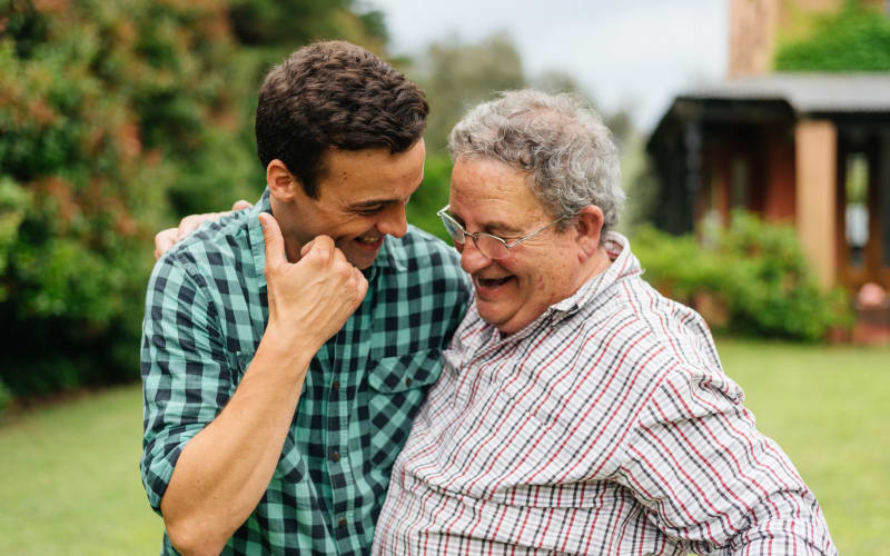 A happy resident with his son at Grand Villa of Boynton Beach in Boynton Beach, Florida