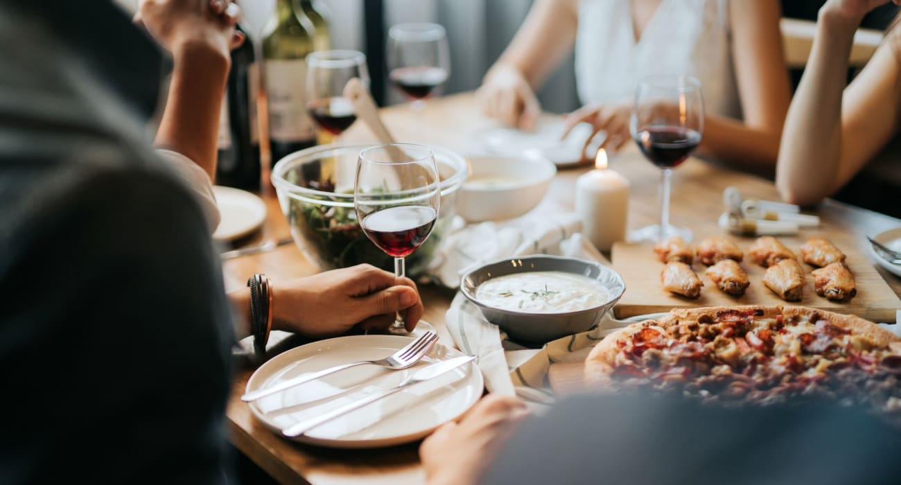 Resident eating lunch and enjoying a glass of wine near Rosedale Manor in Madison, New Jersey