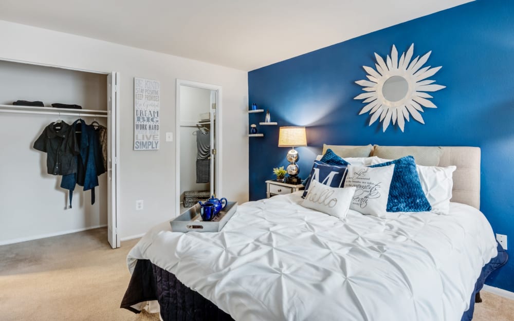 Model bedroom with ample closet space and ensuite bathroom at Avery Park Apartment Homes in Silver Spring, Maryland