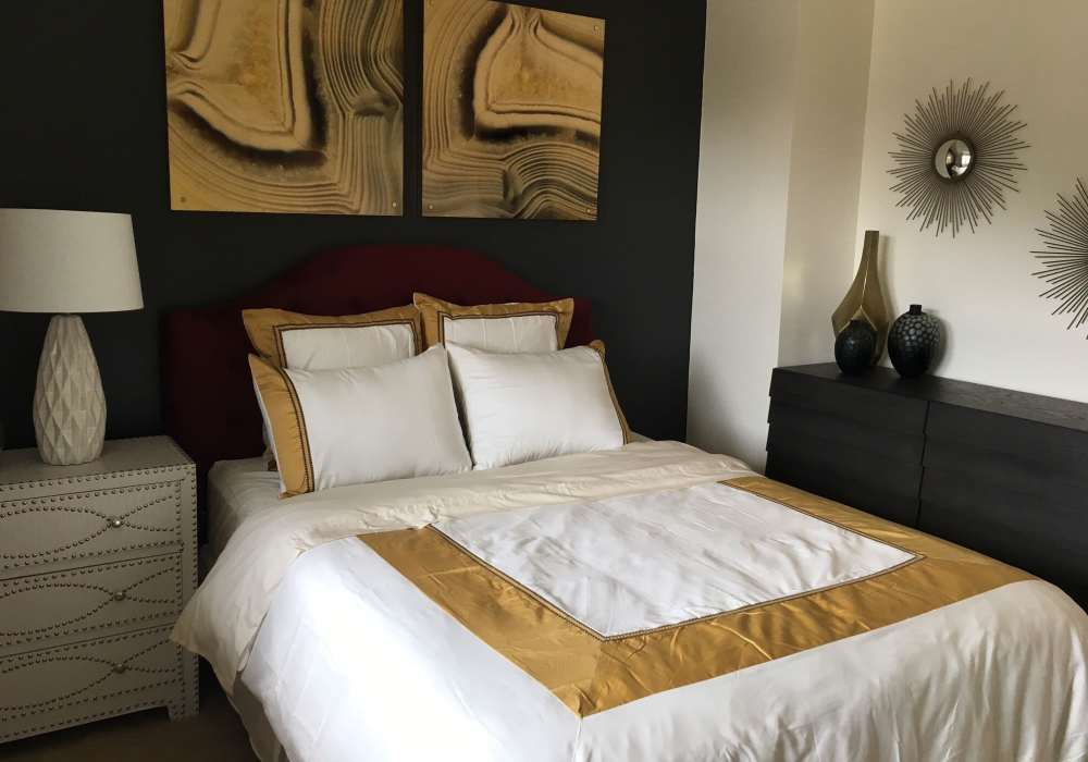 Bed in a furnished bedroom at Pacific Landing in Murrieta, California