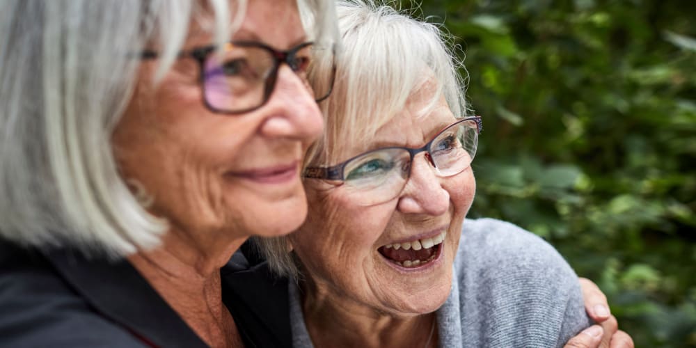 Two women embracing at Ridgeline Management Company in Rockwall, Texas