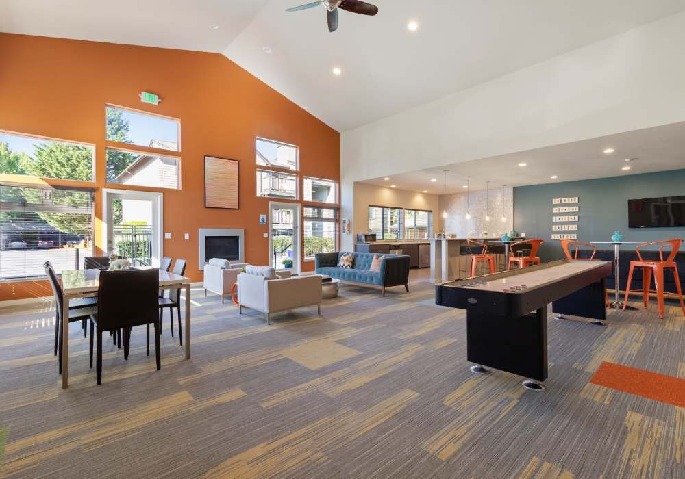 Clubhouse lounge area with games and seating at Foundry on Fifth in Renton, Washington