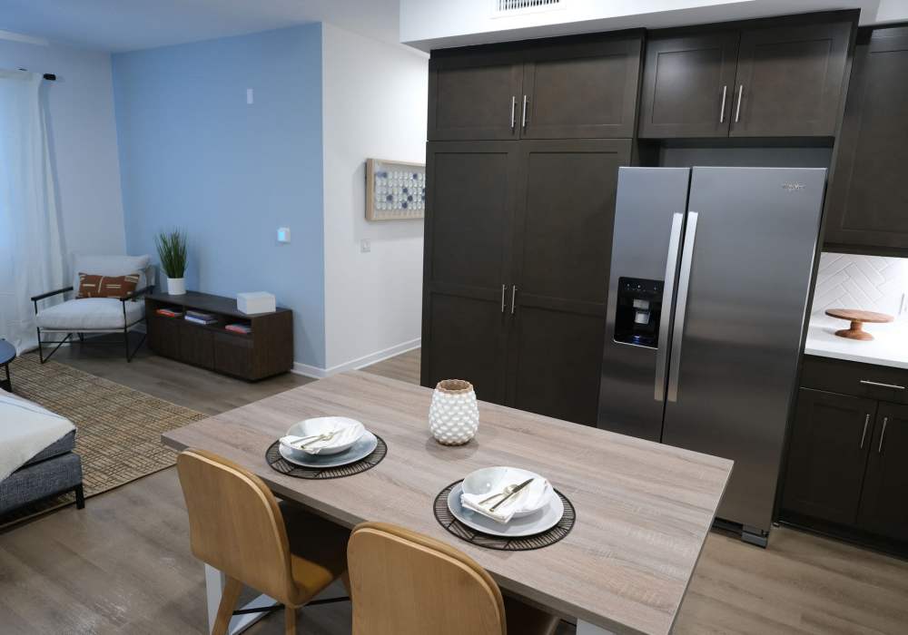 Kitchen with side by side refrigerator at The Courtyards Pacific Village in San Diego, California