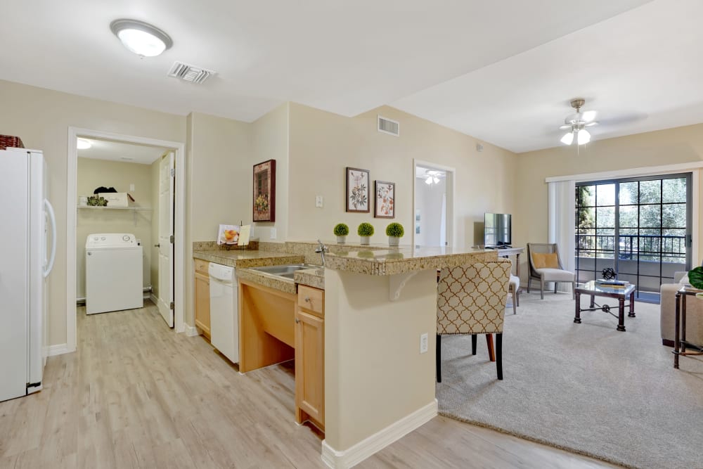 Resident apartment kitchen and living room at Tuscany at McCormick Ranch in Scottsdale, Arizona