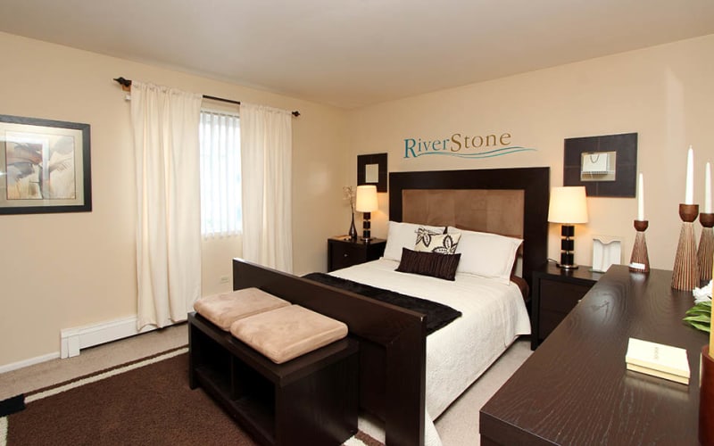 Spacious master bedroom with plush carpeting at Riverstone Apartments in Bolingbrook, Illinois