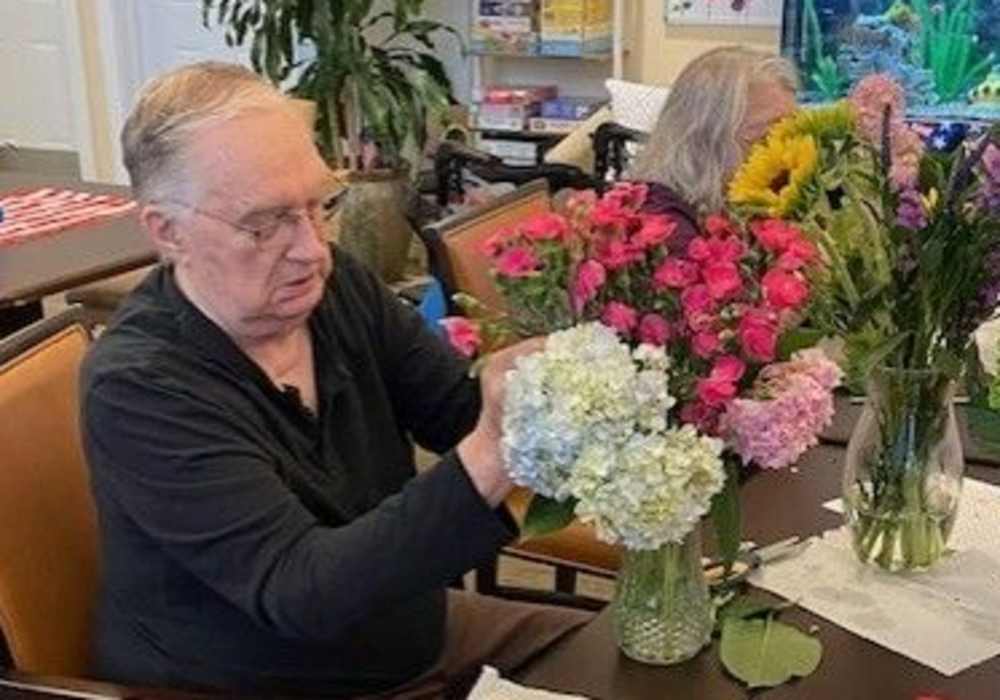 Resident making flower bouquets at Merrill Gardens at Tacoma in Tacoma, Washington