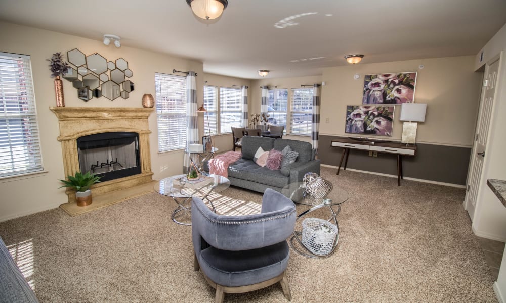 Well decorated living room with a fireplace at Tuscany Place in Lubbock, Texas