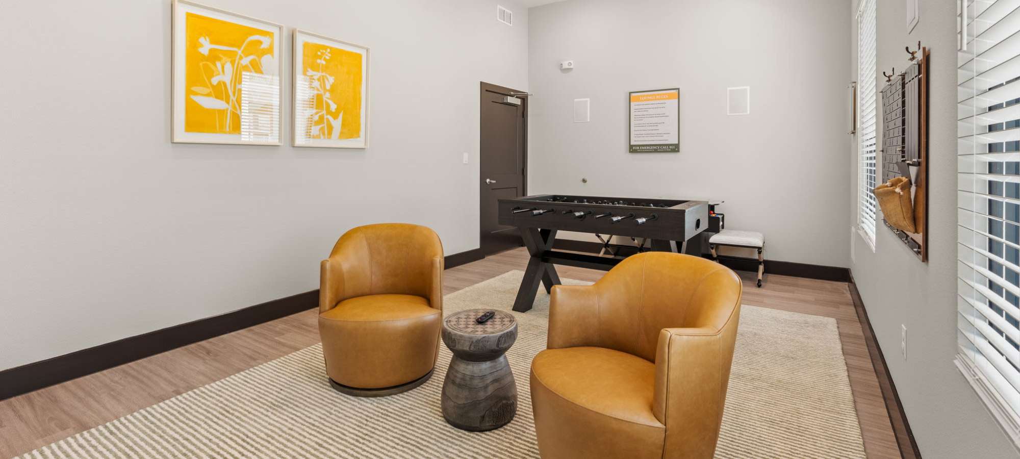 Resident clubhouse seating and foosball at Walnut Springs in Seguin, Texas