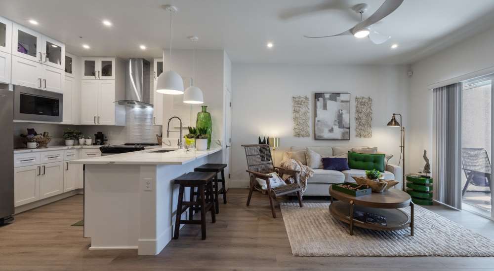 Connected kitchen and living room with sofa at Continuum Apartments in Las Vegas, Nevada