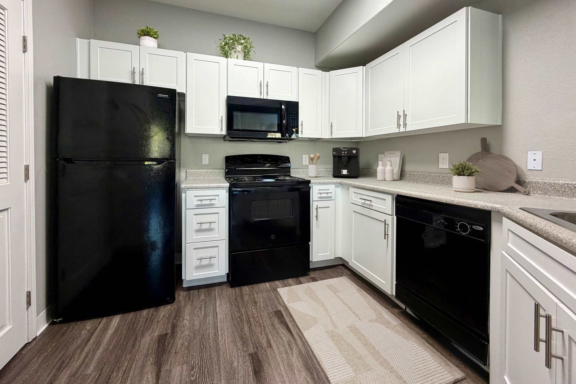 A large kitchen with all the features connecting to living room at The Lofts in Sacramento, California