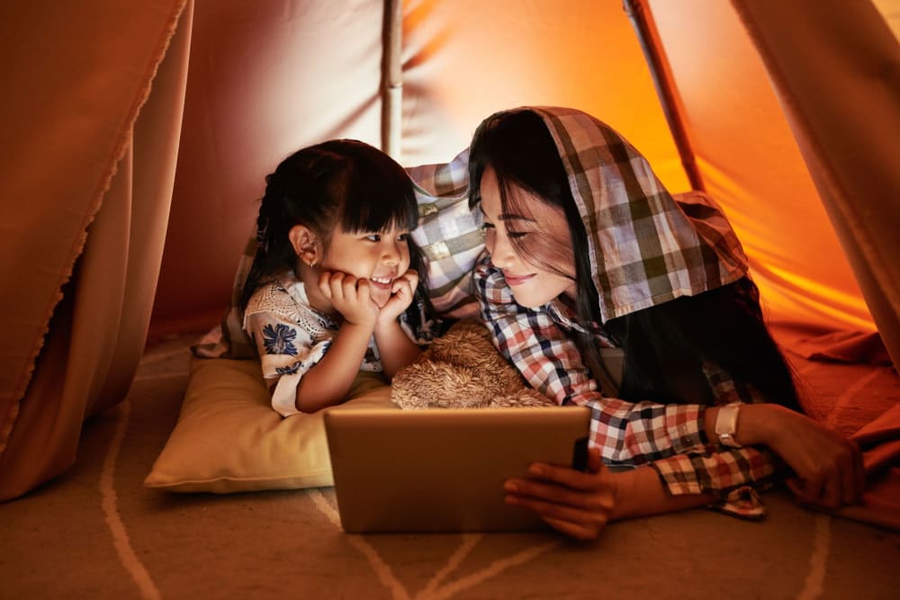 A mother and child looking at a tablet at Vue North Apartments in Rochester, Minnesota