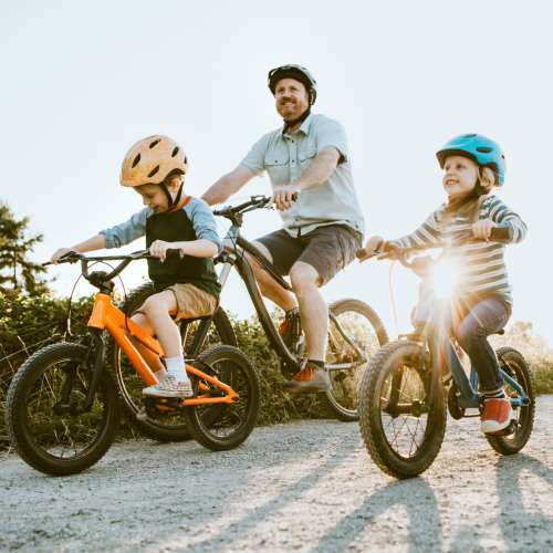 Resident with there kid riding bicycle in trail near South City Apartments in Summerville, South Carolina