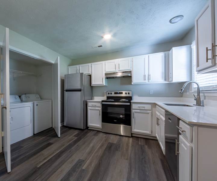 Stainless-steel appliances and wooden cabinets at Cape Fear Townhomes in Fayetteville, North Carolina