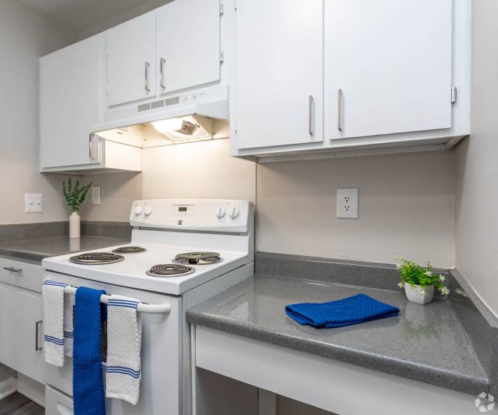 Modern kitchen with white wood cabinet at Landmark Flats in Fayetteville, North Carolina