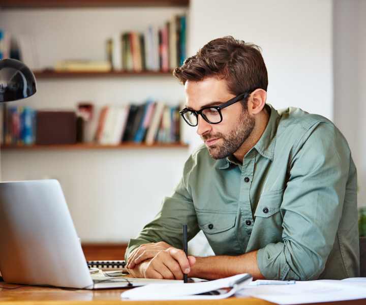 A resident using his laptop for work at El Jardin Apartments in Hollywood, Florida