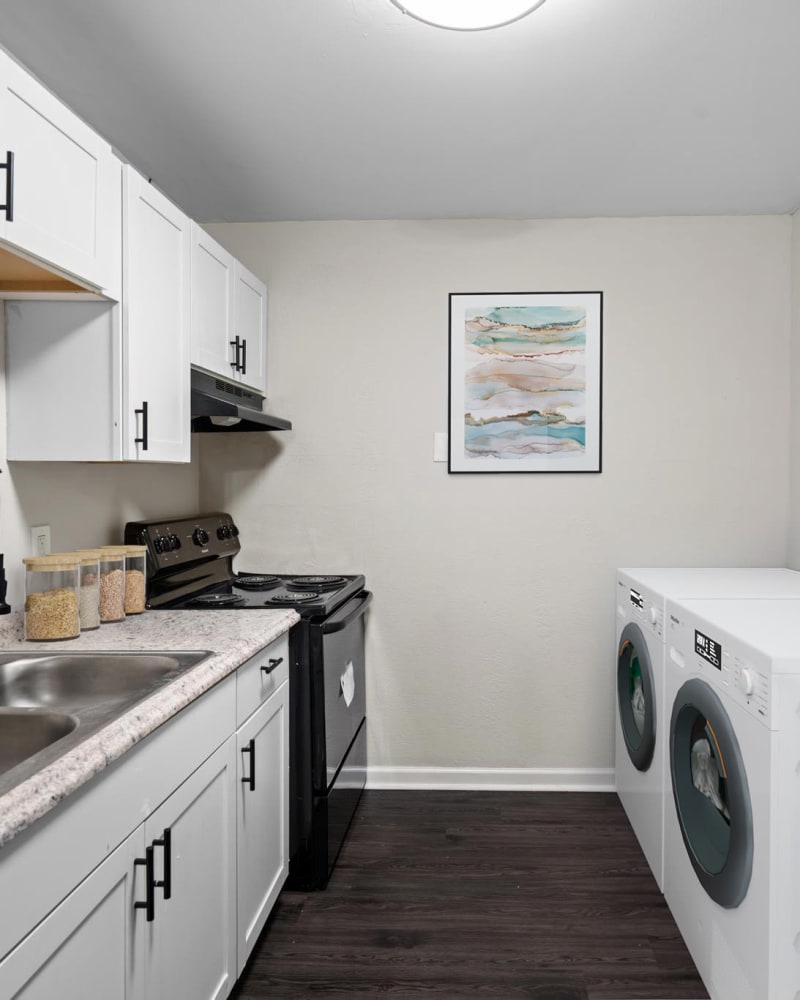 Upgraded appliances and light wood cabinets in a kitchen at Spring Creek Apartment Homes in Decatur, Georgia