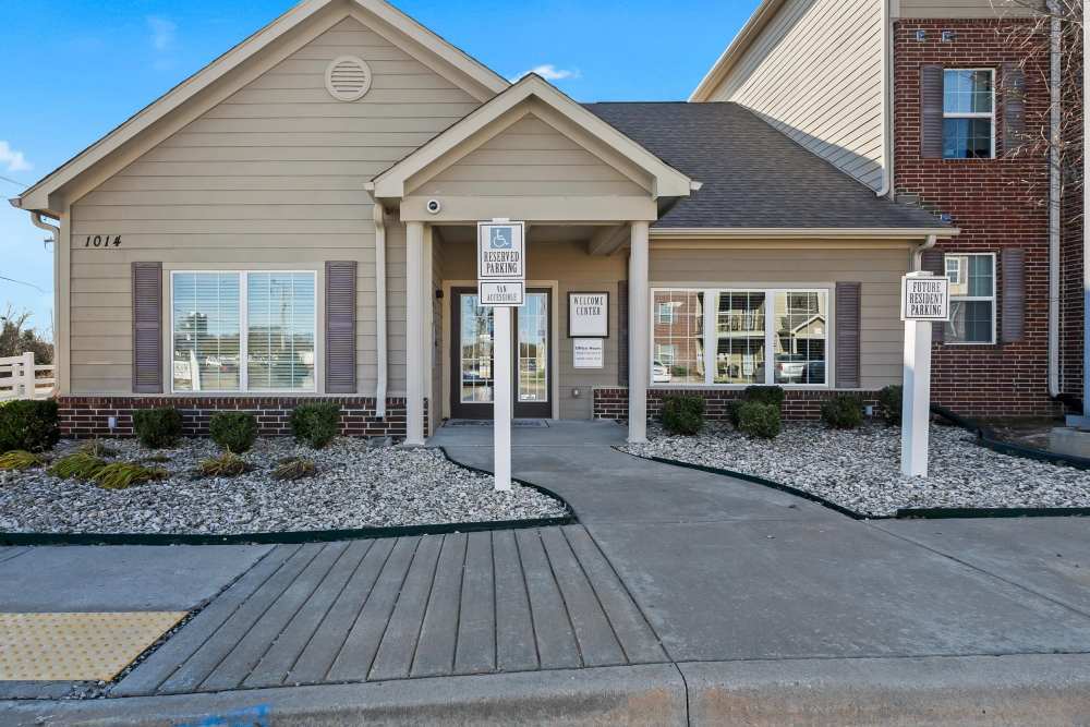 Welcoming entrance with landscaped path and modern architecture at Wickham Gardens in Sapulpa, Oklahoma