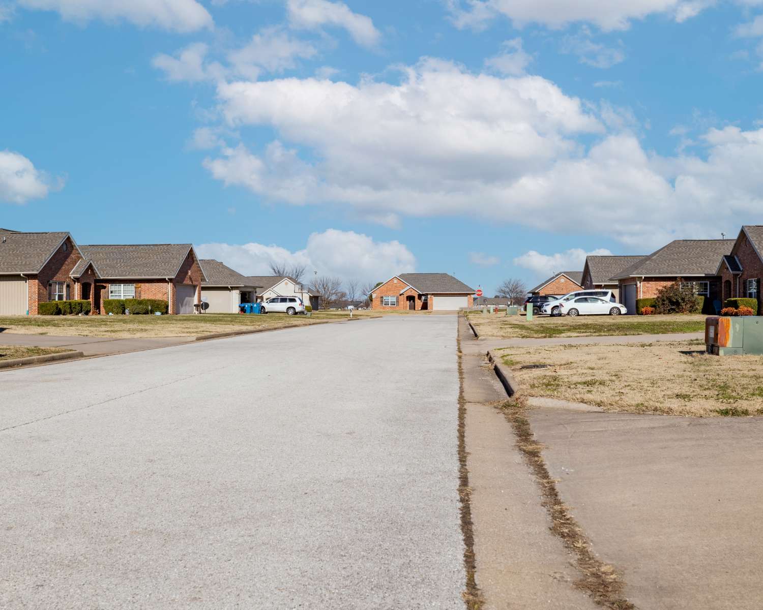 Welcoming neighborhood charm at Prairie Hill Estates II in Carl Junction, Missouri featuring attractive brick homes and open skies.