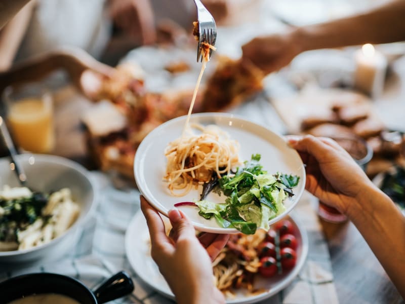 A group of people sharing plates of food near Chace Lake Villas in Birmingham, Alabama