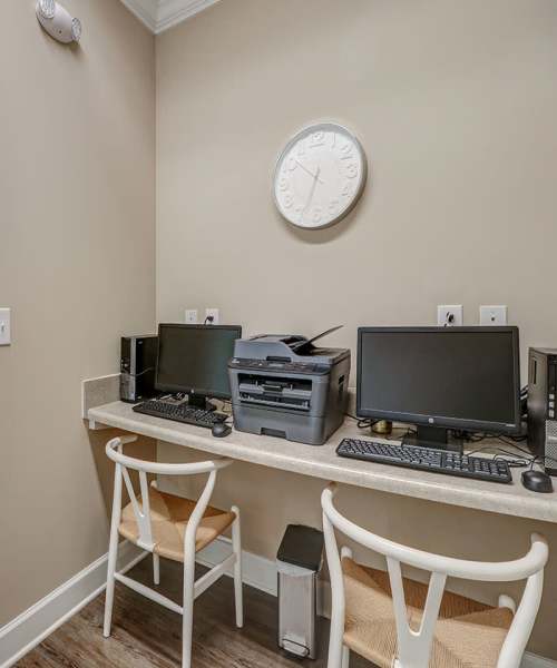 Home office nook with two computers, printer, and light wood-style flooring at Oliver Crossing in Linden, Tennessee