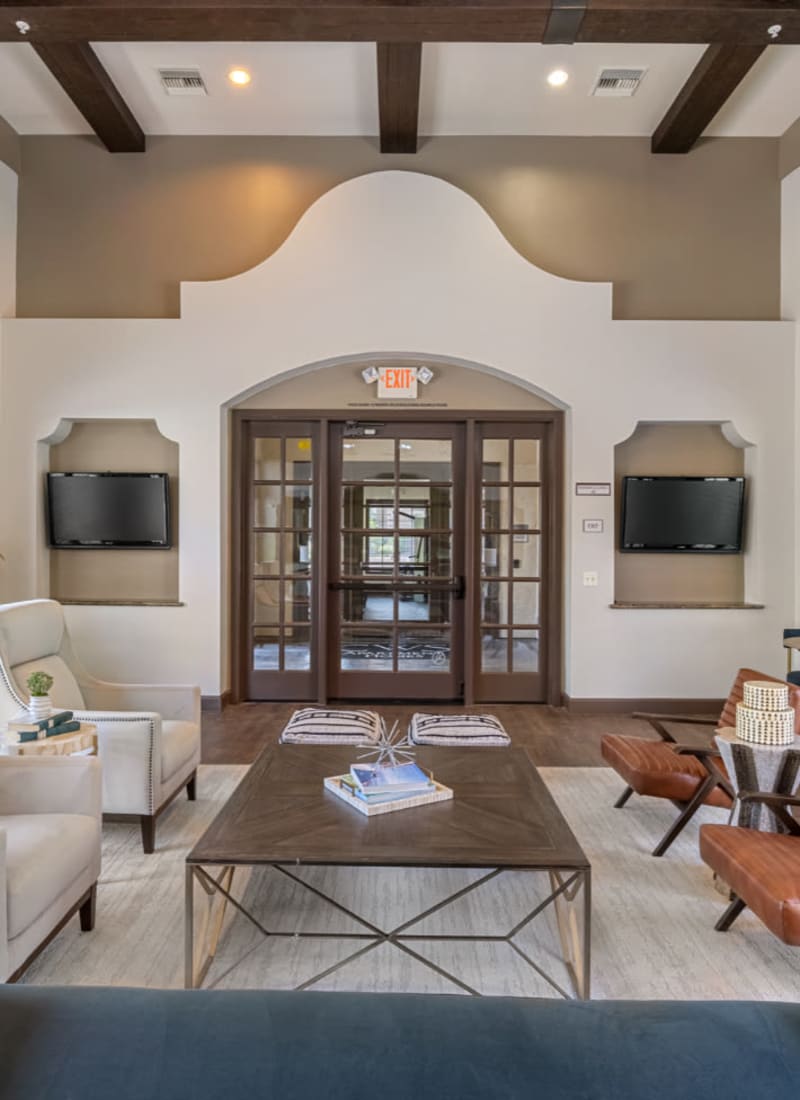 Community clubhouse lounge area with large screen television monitors at Marquis at Sonoran Preserve in Phoenix, Arizona