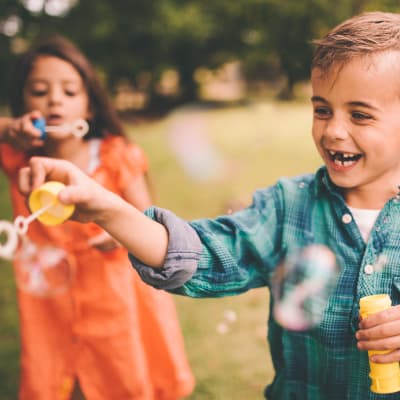  a little boy playing with bubbles at River Place in Lakeside, California