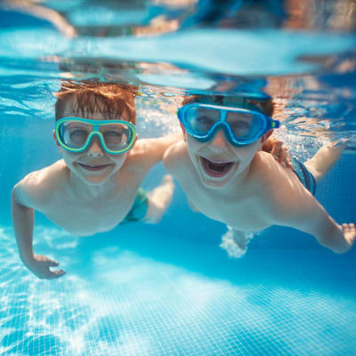 Two kids swimming at The Towne at Northgate Apartments in Colorado Springs, Colorado